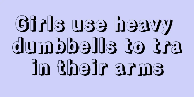 Girls use heavy dumbbells to train their arms