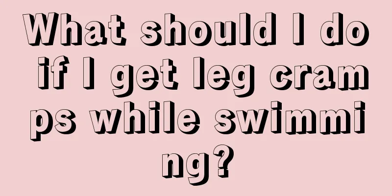 What should I do if I get leg cramps while swimming?